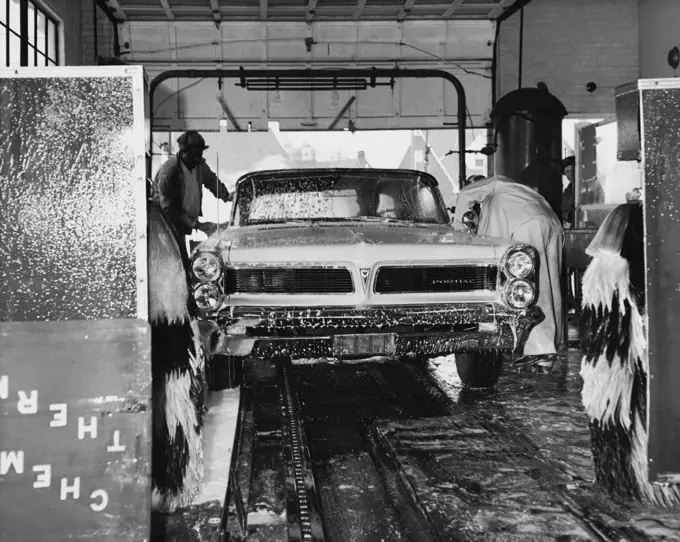 Two attendants washing a car