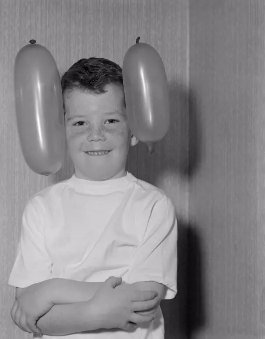 Portrait of boy with two balloons