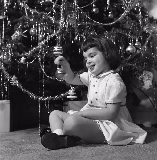 Small girl holding Christmas bauble