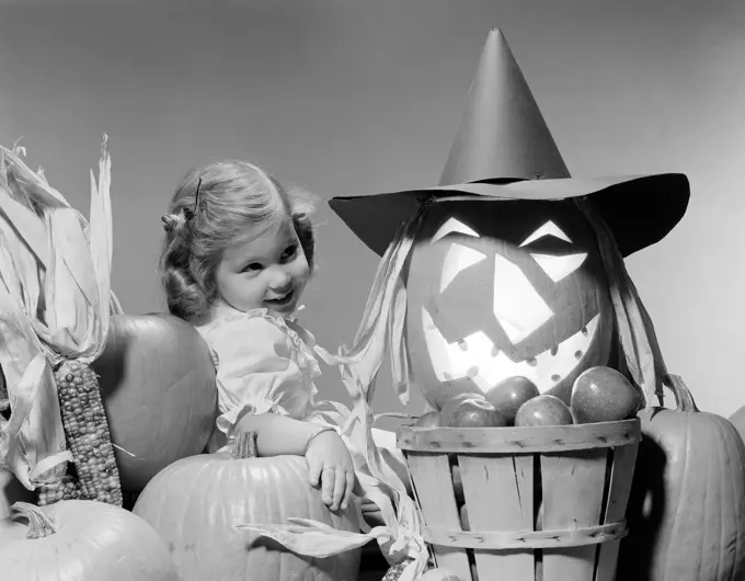 Girl around Halloween decorations, studio shot