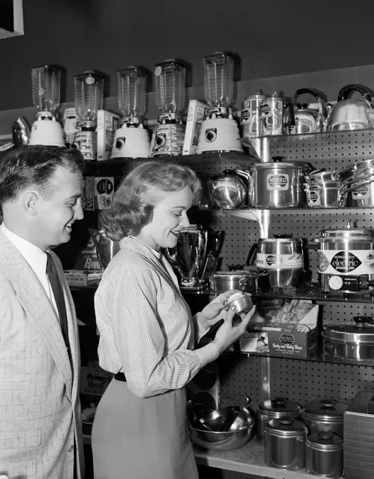 Woman in shop with kitchen utensils