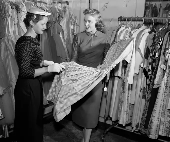 Woman choosing dress in shop