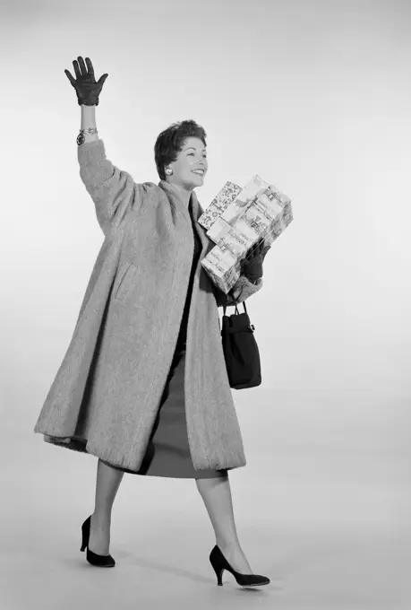 Studio shot of mid adult woman with shopping