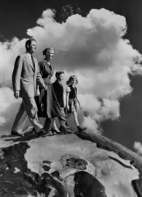 Family with two kids walking in clouds