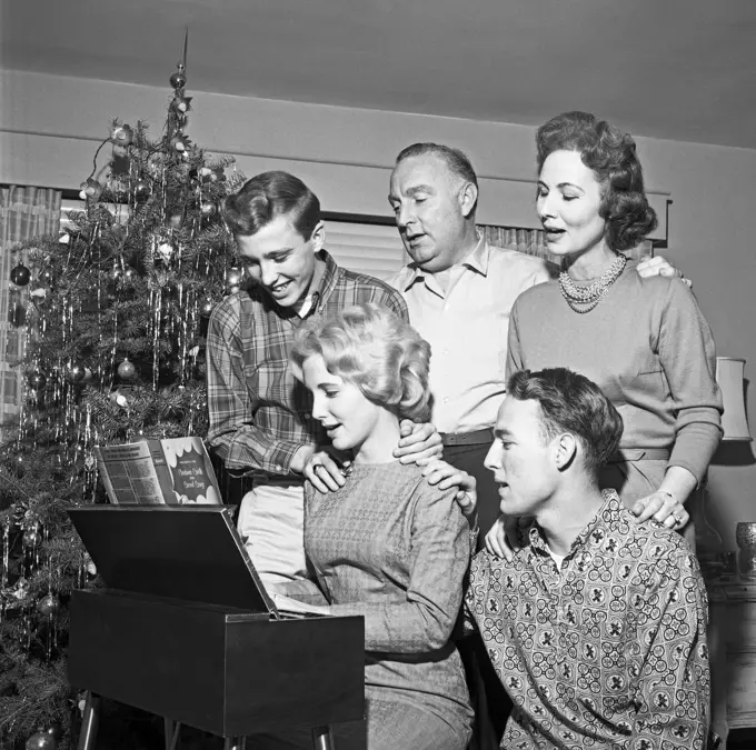 Family playing and singing Christmas carols