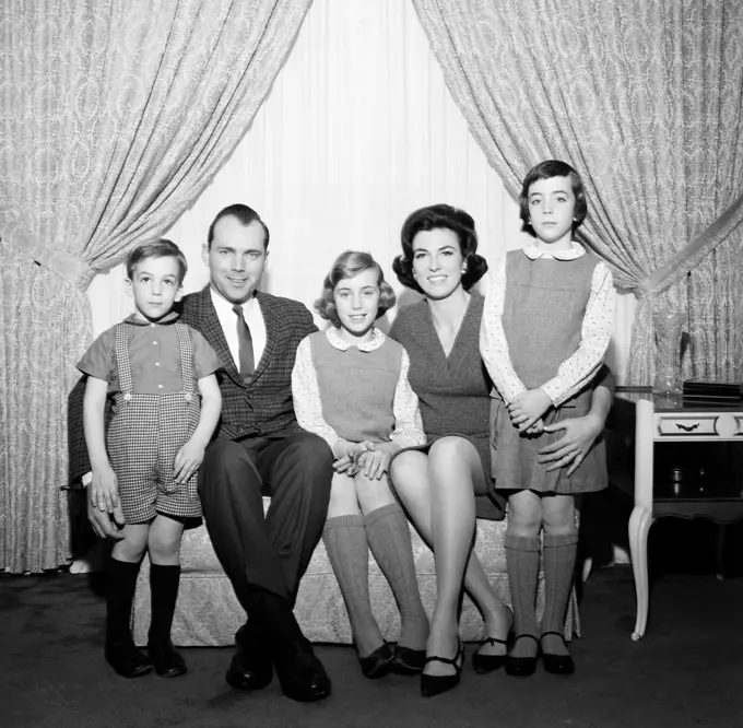 Portrait of family with children in living room