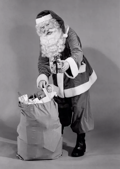 Father christmas pulling present from sack