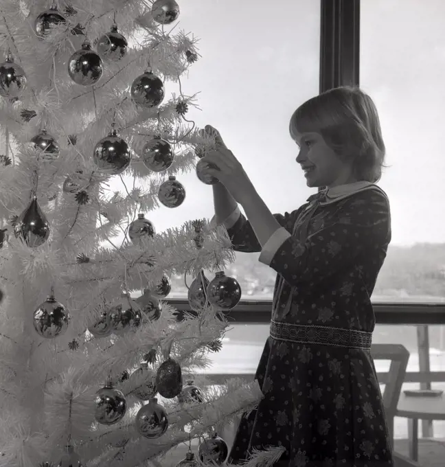 Girl decorating Christmas tree