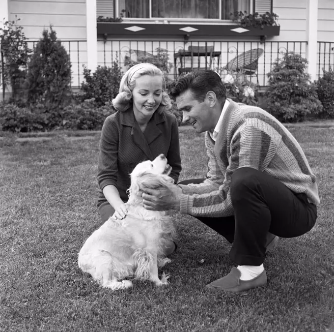 Couple playing with dog