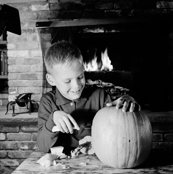 Boy preparing pumpkin for Halloween