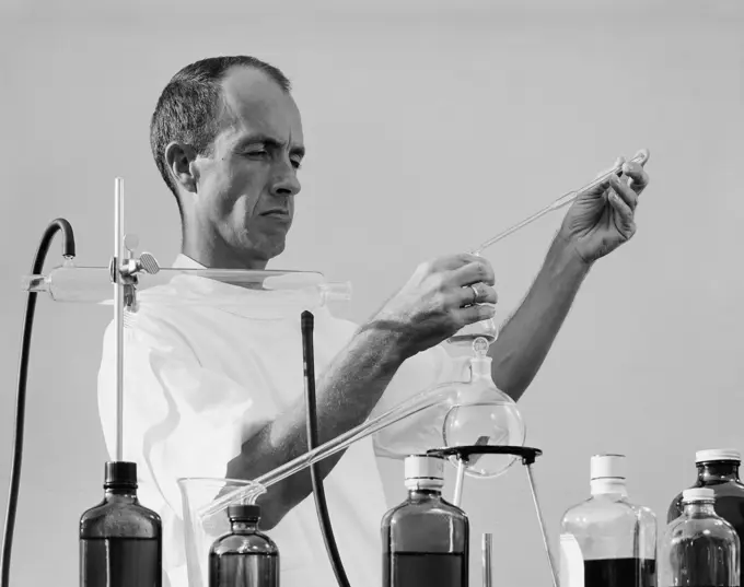 Scientist mixing chemicals in laboratory