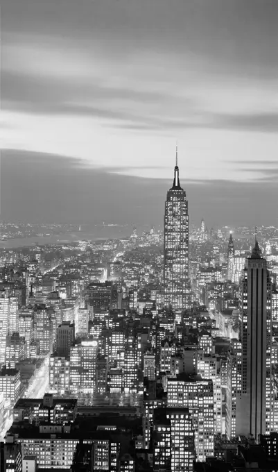 USA, New York State, New York City, Night view over Midtown and Lower areas of Manhattan with Empire State building silhouetted against the evening sky