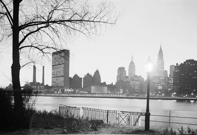 USA, New York State, New York City, Midtown Manhattan skyline with United Nations Buildings at dusk