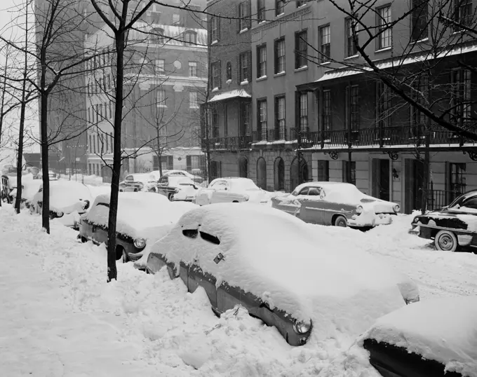 USA, New York State, New York City, Beekman Place on East side near 51st Street, snow covered automobiles line curbs