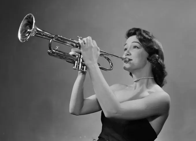 Young woman playing trumpet