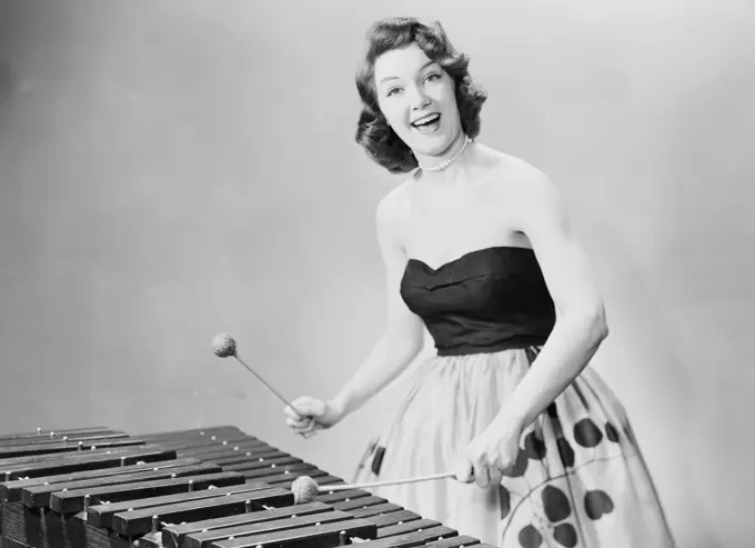 Young woman playing hammered dulcimer