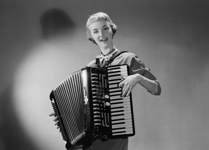 Young woman playing accordion