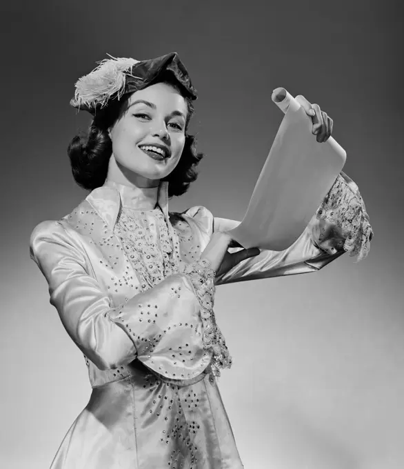 Young woman wearing period costume holding scroll