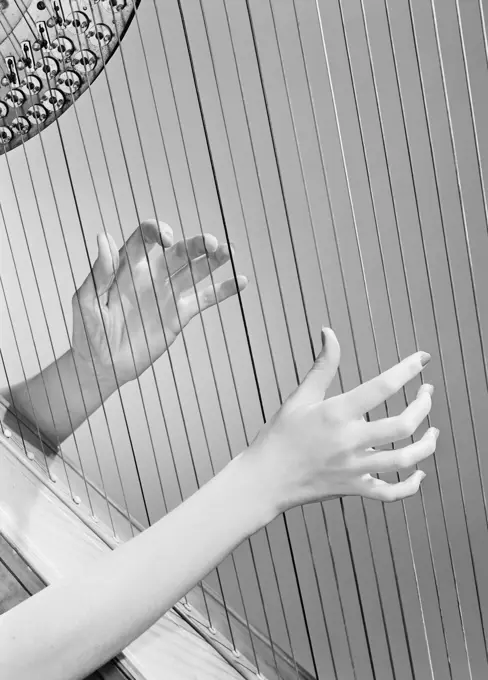 Hands playing harp