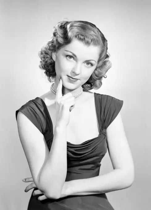 Portrait of young woman wearing evening gown