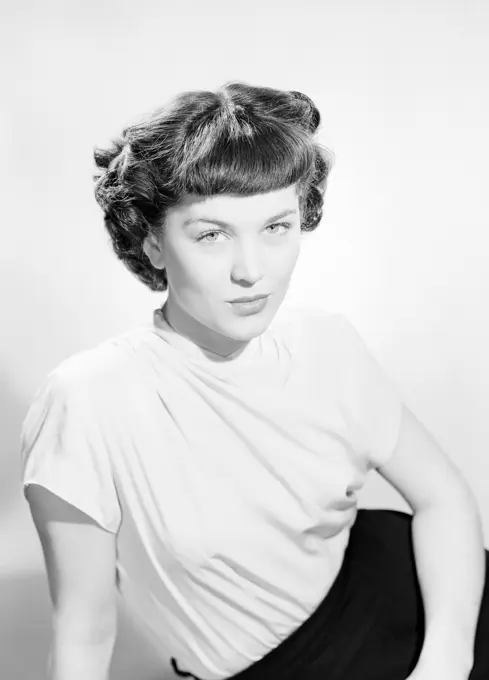 Studio portrait of young woman sitting