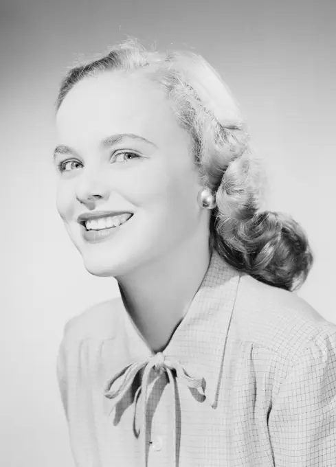 Studio portrait of young woman smiling