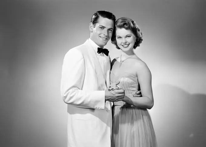 Studio portrait of young couple dancing