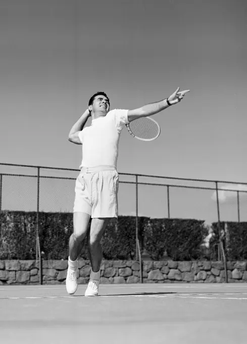 Male tennis player serving