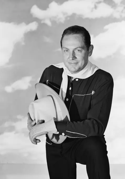 Portrait of man holding cowboy hat