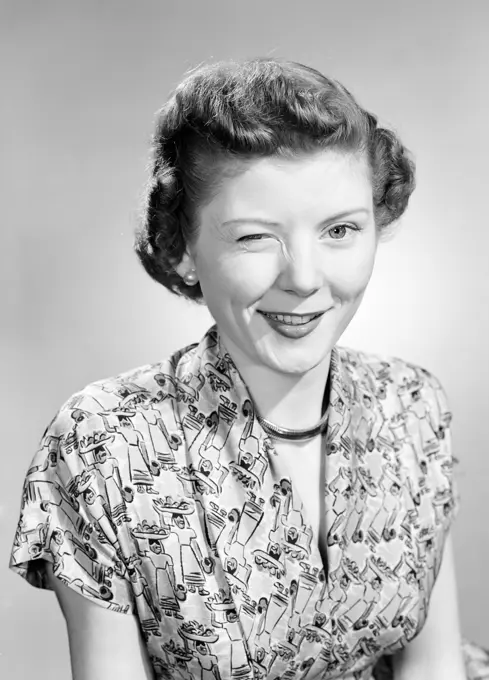 Studio portrait of woman winking