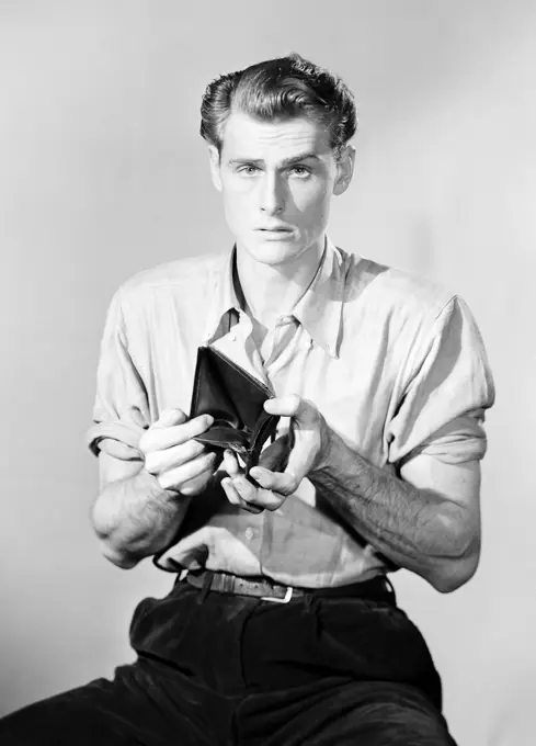 Studio portrait of man with empty wallet