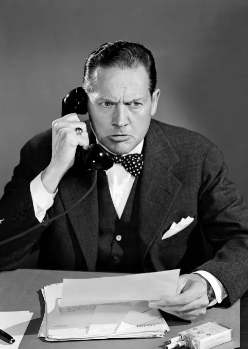 Businessman using office telephone