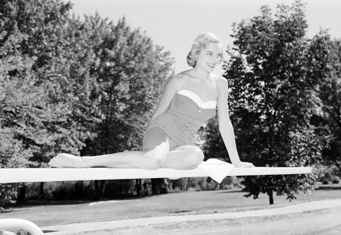 Young woman in swimming costume on diving board