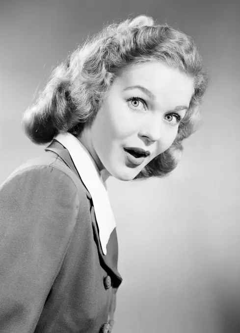 Studio portrait of surprised young woman