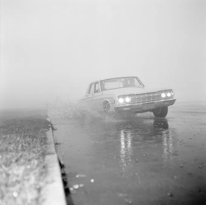 Car on foggy winter road