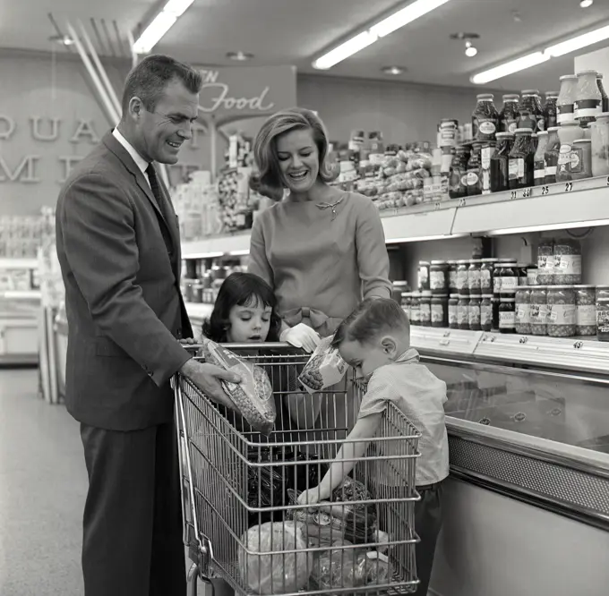 Family with children shopping in supermarket