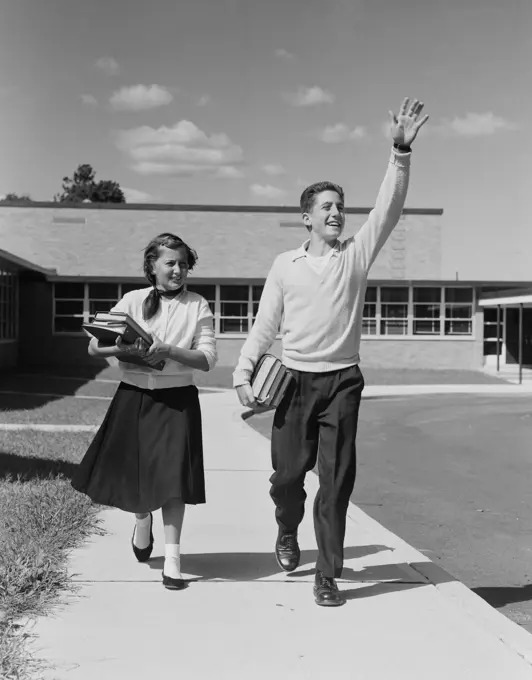 Boy and girl walking front school