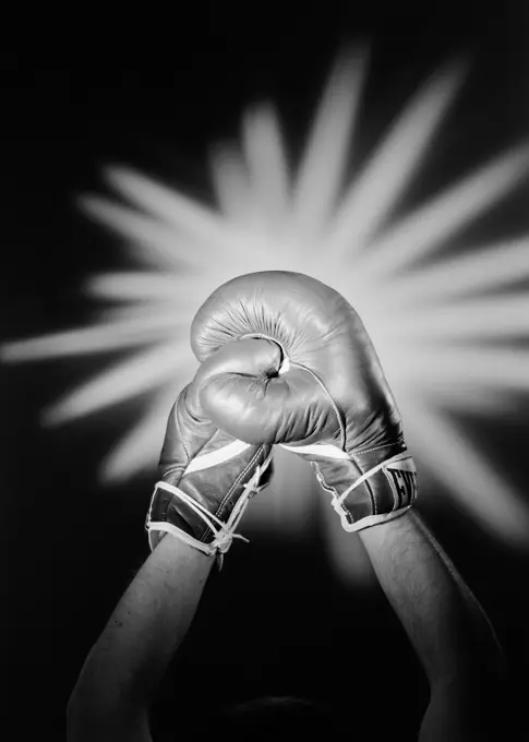 Hands wearing boxing gloves celebrating victory