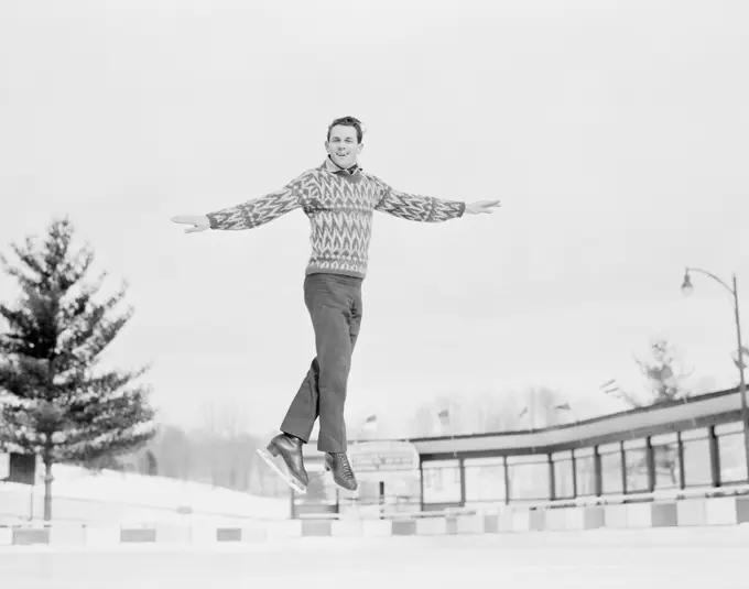 Man jumping while ice skating