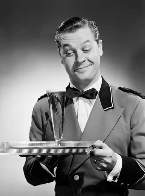 Waiter carrying beverage on tray