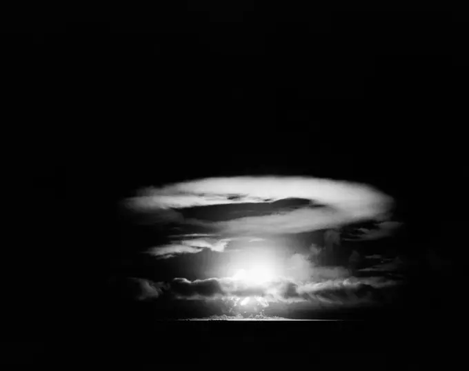 Pacific Ocean, Eniwetok Atoll, Fire ball of nuclear detonation rises through clouds during tests in 1951