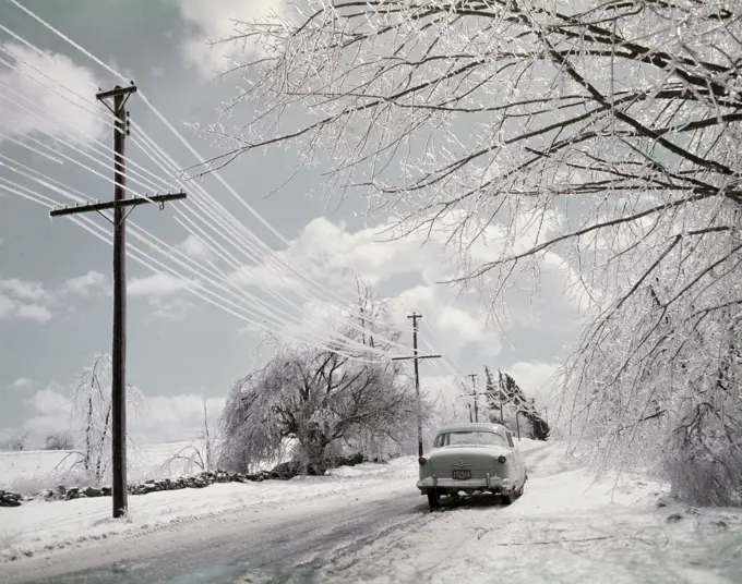 Car on rural road in winter