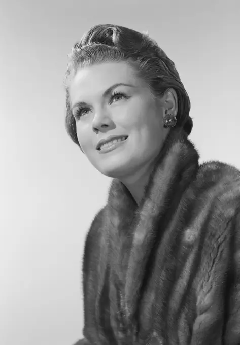 Studio portrait of mid adult woman smiling