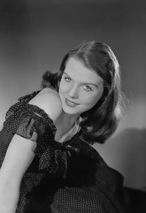 Studio portrait of young woman smiling