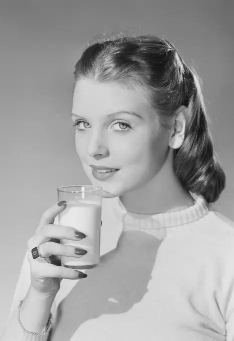 Young woman holding glass of milk