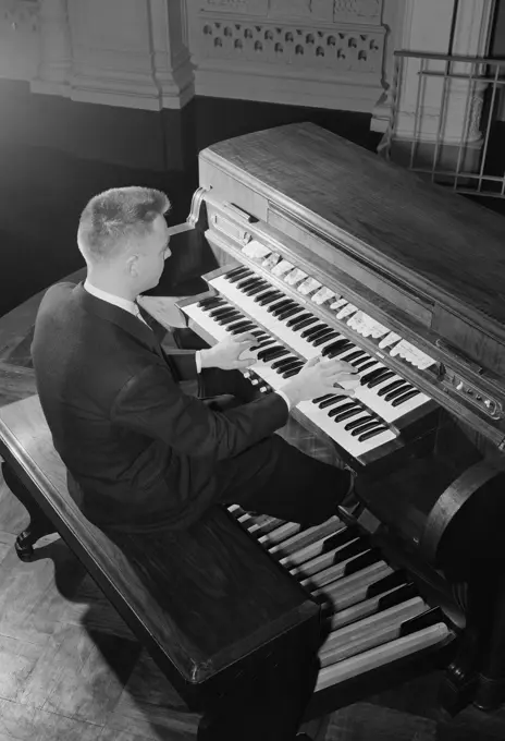 Man playing organ in church