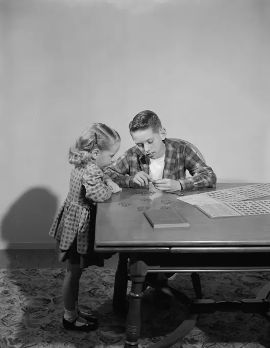 Girl examining collectable post stamps