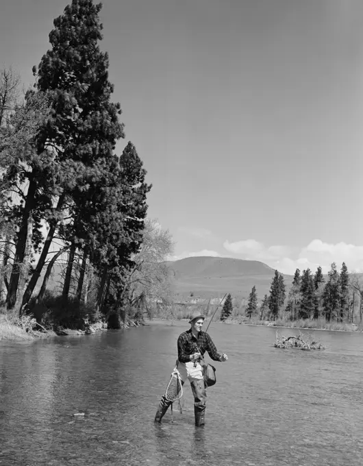 Man fly-fishing in mountain river