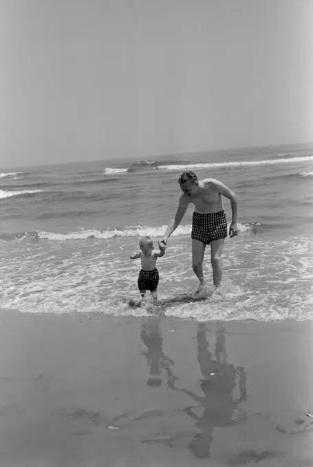 Father and son playing on beach