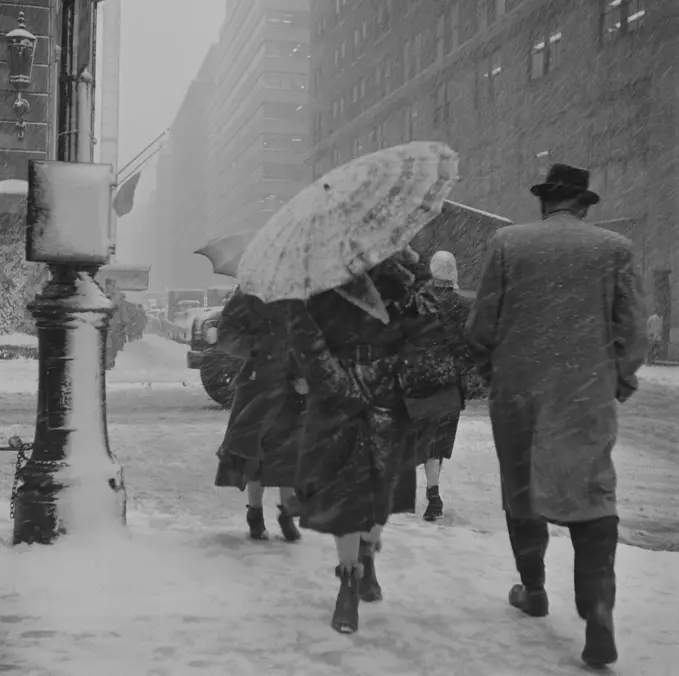 USA, New York City, People walking in snowstorm